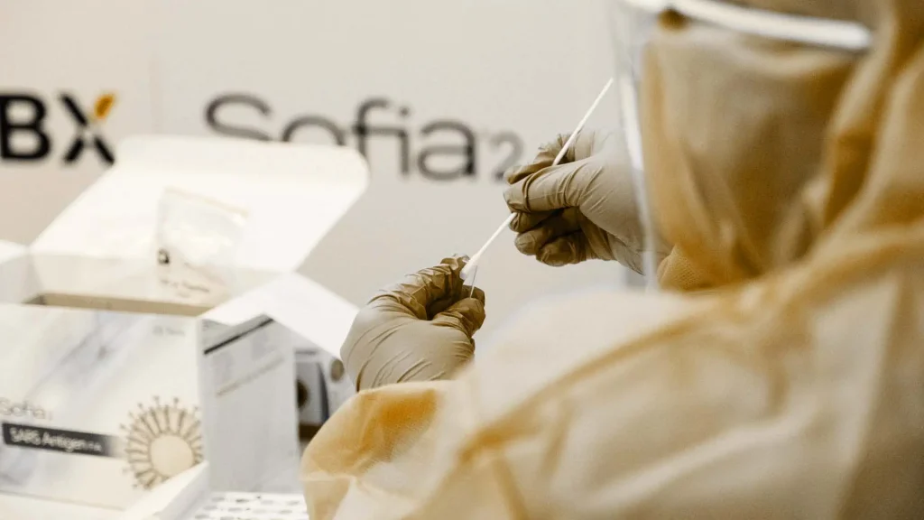 person with medical gloves swopping a sample